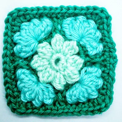 Ice flower granny square - free crochet pattern by Crochet Cloudberry. This pattern uses simple stitches to create raised petals and leaves.